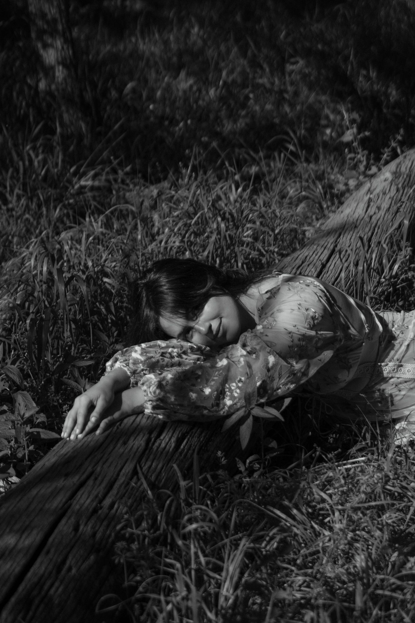 A woman resting on a fallen log